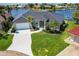 Aerial view featuring a well manicured lawn, elegant driveway, and stunning home at 261 Venezia Ct, Punta Gorda, FL 33950