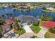 Aerial view featuring a home with mature landscaping, boat dock, and beautiful surroundings at 261 Venezia Ct, Punta Gorda, FL 33950