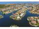 Aerial view of a waterfront community, featuring residential homes with boat docks along a network of canals and waterways at 261 Venezia Ct, Punta Gorda, FL 33950