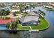 Aerial view of the home, backyard pool, and boat dock along the canal at 261 Venezia Ct, Punta Gorda, FL 33950