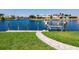 Manicured backyard with pavers leading to a private dock on the canal with boat lift at 261 Venezia Ct, Punta Gorda, FL 33950