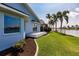 Manicured backyard with a small deck overlooking the canal at 261 Venezia Ct, Punta Gorda, FL 33950