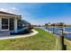 Landscaped backyard featuring waterfront views and a private boat dock at 261 Venezia Ct, Punta Gorda, FL 33950