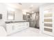 Bright bathroom featuring double sinks, marble counters, and a glass-enclosed shower at 261 Venezia Ct, Punta Gorda, FL 33950