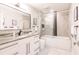 Modern bathroom featuring a double vanity, soaking tub, and glass-enclosed shower at 261 Venezia Ct, Punta Gorda, FL 33950