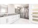 Bright bathroom featuring double sinks, marble counters, and a glass-enclosed shower at 261 Venezia Ct, Punta Gorda, FL 33950