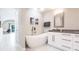 Elegant bathroom featuring a modern soaking tub and white vanity at 261 Venezia Ct, Punta Gorda, FL 33950