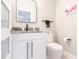 Stylish half bathroom features modern vanity with black fixtures and marble-look countertop at 261 Venezia Ct, Punta Gorda, FL 33950