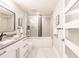 Modern bathroom featuring a double vanity, soaking tub, and glass-enclosed shower at 261 Venezia Ct, Punta Gorda, FL 33950