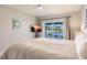 Bright bedroom featuring a waterfront view and sliding glass doors opening to the outside at 261 Venezia Ct, Punta Gorda, FL 33950