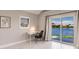 Bright bedroom featuring a white desk, chair, and waterfront access at 261 Venezia Ct, Punta Gorda, FL 33950