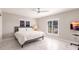 Bright bedroom featuring plantation shutters and a ceiling fan at 261 Venezia Ct, Punta Gorda, FL 33950