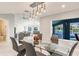 Bright dining area features a modern table with views of the pool and waterway at 261 Venezia Ct, Punta Gorda, FL 33950