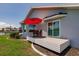 Exterior of home with a patio, umbrella and seating overlooking yard at 261 Venezia Ct, Punta Gorda, FL 33950