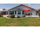 Home exterior featuring a patio with an umbrella and seating area at 261 Venezia Ct, Punta Gorda, FL 33950