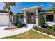 Elegant front entrance featuring a bright orange door and manicured landscaping at 261 Venezia Ct, Punta Gorda, FL 33950