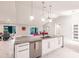 Modern kitchen features a stainless dishwasher, marble countertop island, and pendant lights at 261 Venezia Ct, Punta Gorda, FL 33950