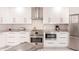 Modern kitchen features stainless appliances, white cabinetry, and marble countertops at 261 Venezia Ct, Punta Gorda, FL 33950