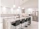 Modern kitchen featuring sleek white cabinetry, a large marble island, and stainless appliances at 261 Venezia Ct, Punta Gorda, FL 33950