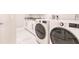 Modern laundry room with marble floors, granite countertops, and LG washer and dryer at 261 Venezia Ct, Punta Gorda, FL 33950