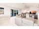 Living room with marble floors, a large tv and sliders to the lanai and pool at 261 Venezia Ct, Punta Gorda, FL 33950
