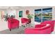 Bright open living room with modern chairs overlooking pool and waterway at 261 Venezia Ct, Punta Gorda, FL 33950