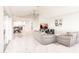 Bright open floorplan showcases sleek gray couches, marble flooring and open access to the kitchen at 261 Venezia Ct, Punta Gorda, FL 33950