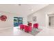 Bright living room with white marble flooring, red chairs, and sliding glass doors at 261 Venezia Ct, Punta Gorda, FL 33950