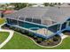 Screened-in pool featuring a jacuzzi at 261 Venezia Ct, Punta Gorda, FL 33950