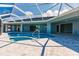 Enjoy the refreshing pool area with screened enclosure, perfect for relaxation and outdoor living with beautiful landscaping at 261 Venezia Ct, Punta Gorda, FL 33950