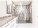 Modern shower featuring sleek marble-style tiling and recessed shelving at 261 Venezia Ct, Punta Gorda, FL 33950