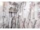 Modern glass-enclosed shower featuring luxurious marble-style tiling at 261 Venezia Ct, Punta Gorda, FL 33950