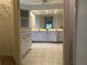 Bright bathroom with a dual sink vanity, white cabinetry, tile flooring and large mirror at 3233 Meadow Run Dr, Venice, FL 34293