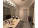 Cozy bathroom featuring a vanity, toilet, framed mirror and enclosed glass shower at 3233 Meadow Run Dr, Venice, FL 34293