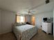 Comfortable bedroom featuring a large bed and a chest of drawers at 3233 Meadow Run Dr, Venice, FL 34293
