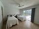Cozy bedroom featuring twin beds and sliding glass doors to the pool area at 3233 Meadow Run Dr, Venice, FL 34293