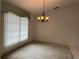 Inviting dining room featuring a chandelier and carpeted floors at 3233 Meadow Run Dr, Venice, FL 34293