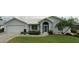 Charming single-story home with a well-manicured lawn and beautiful landscaping at 3233 Meadow Run Dr, Venice, FL 34293