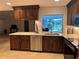Beautiful kitchen featuring wooden cabinetry, granite countertops, and stainless steel appliances at 3233 Meadow Run Dr, Venice, FL 34293