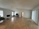 Open-concept living room with fireplace and natural light at 3233 Meadow Run Dr, Venice, FL 34293