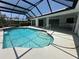 Inviting screened-in pool features clear blue water, covered patio, and ample space for outdoor enjoyment at 3233 Meadow Run Dr, Venice, FL 34293