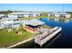 Stunning aerial view showcasing the community pool, pier, gazebo, and scenic lakeside apartments at 3310 Loveland Blvd # 2304, Punta Gorda, FL 33980