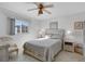 Cozy bedroom featuring a full bed, wood-look floors, and lots of natural light at 3310 Loveland Blvd # 2304, Punta Gorda, FL 33980