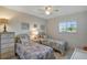Comfortable bedroom with twin beds, a ceiling fan, and natural light from the large window at 3310 Loveland Blvd # 2304, Punta Gorda, FL 33980
