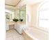 Bright bathroom featuring white cabinets, tile floor, and a soaking tub at 3506 Saint Florent Ct, Punta Gorda, FL 33950