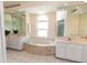 A luxurious bathroom showcasing dual sinks and a garden tub with stone accents at 3506 Saint Florent Ct, Punta Gorda, FL 33950