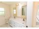 Bathroom featuring double sinks, decorative mirrors, mosaic backsplash, and stylish cabinets at 3506 Saint Florent Ct, Punta Gorda, FL 33950