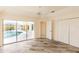 Bright bedroom features stylish floors, closet, and sliding glass doors to the pool at 3506 Saint Florent Ct, Punta Gorda, FL 33950