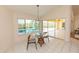 Bright breakfast nook boasts a cozy dining set with views of the pool area and natural light at 3506 Saint Florent Ct, Punta Gorda, FL 33950