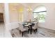 Dining area featuring an elegant chandelier and a beautiful arched window showcasing the lush exterior at 3506 Saint Florent Ct, Punta Gorda, FL 33950